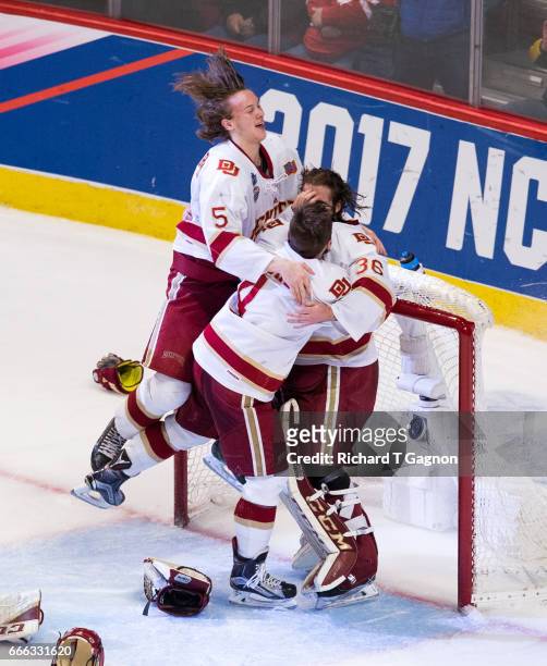 Tanner Jaillet, Henrik Borgstrom and Will Butcher all of the Denver Pioneers celebrate a victory against the Minnesota Duluth Bulldogs during the...