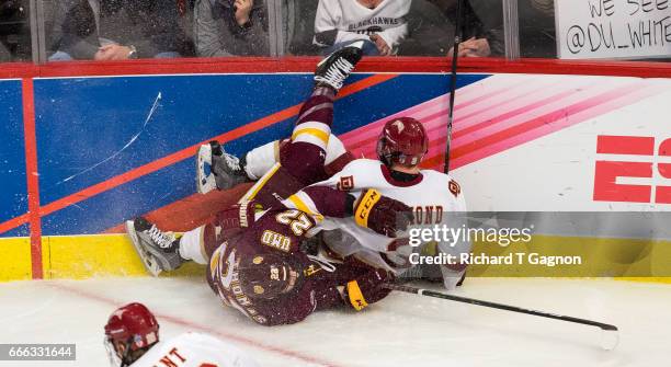 Tariq Hammond of the Denver Pioneers and Jared Thomas of the Minnesota Duluth Bulldogs crash into the boards during the 2017 NCAA Division I Men's...