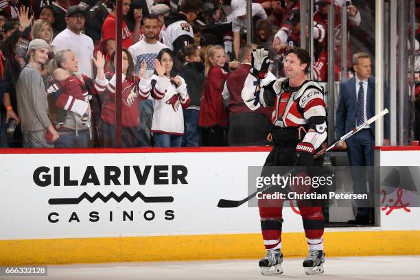 Shane Doan of the Arizona Coyotes waves to fans as he skates off the ice following the NHL game against the Minnesota Wild at Gila River Arena on...