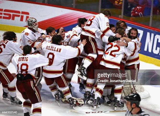 Members of the Denver Pioneers mob goaltender Tanner Jaillet after w in over the Minnesota-Duluth Bulldogs during the 2017 NCAA Division I Men's Ice...