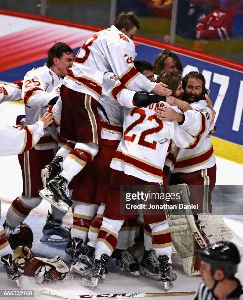 Members of the Denver Pioneers mob goaltender Tanner Jaillet after w in over the Minnesota-Duluth Bulldogs during the 2017 NCAA Division I Men's Ice...