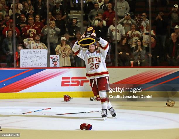 Evan Janssen of the Denver Pioneers holds the trophy after a win over the Minnesota-Duluth Bulldogs during the 2017 NCAA Division I Men's Ice Hockey...