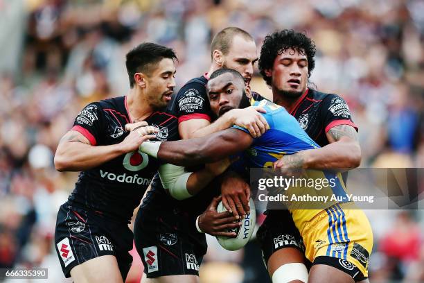 Semi Radradra of the Eels is tackled by Shaun Johnson, Simon Mannering and James Gavet of the Warriors during the round six NRL match between the New...