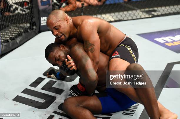 Daniel Cormier takes down Anthony Johnson in their UFC light heavyweight championship bout during the UFC 210 event at KeyBank Center on April 8,...