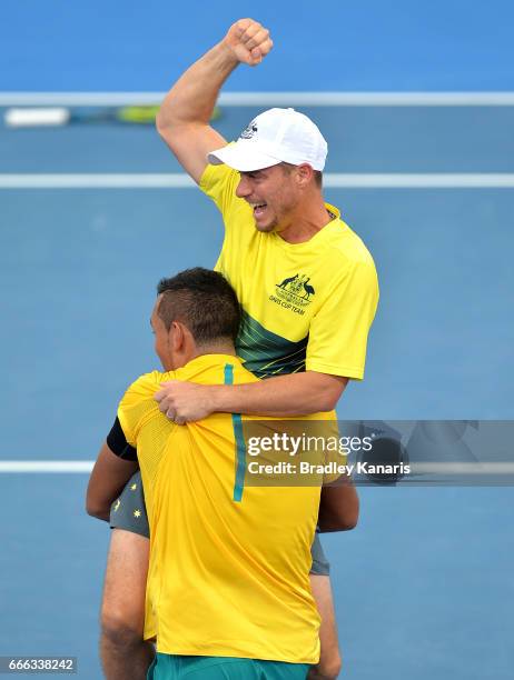 Nick Kyrgios of Australia celebrates victory with Team Captain Lleyton Hewitt after his match against Sam Querrey of the USA during the Davis Cup...