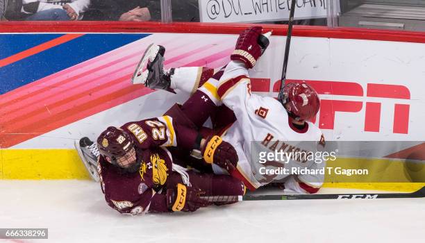 Tariq Hammond of the Denver Pioneers and Jared Thomas of the Minnesota Duluth Bulldogs crash into the boards during the 2017 NCAA Division I Men's...