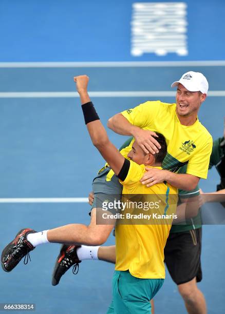 Nick Kyrgios of Australia celebrates victory with Team Captain Lleyton Hewitt after his match against Sam Querrey of the USA during the Davis Cup...