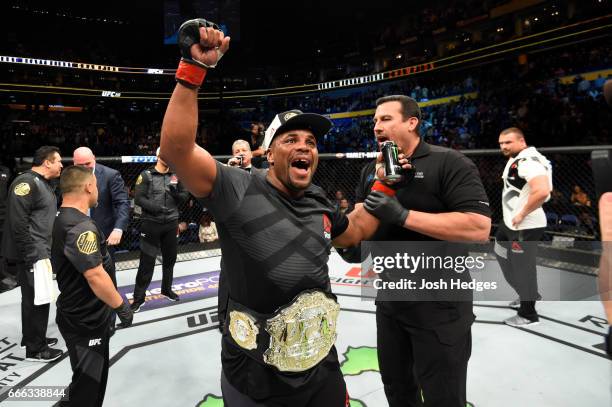 Daniel Cormier celebrates his rear choke submission victory over Anthony Johnson in their UFC light heavyweight championship bout during the UFC 210...