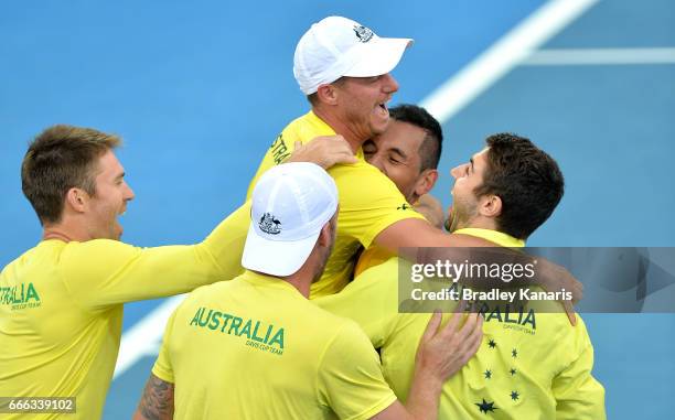 Team Captain Lleyton Hewitt of Australia celebrates victory with his team of Nick Kyrgios, Sam Groth, Jordan Thompson and Joh Peers after the match...