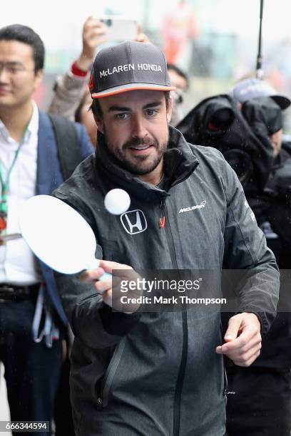 Fernando Alonso of Spain and McLaren Honda plays ping pong before the drivers parade during the Formula One Grand Prix of China at Shanghai...