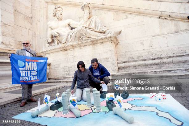 An enlarged version of the game RisiKo using models or armoured tanks and water hydrants is displayed in a flash mob protest beside the Campidoglio...