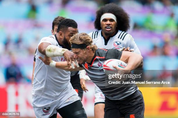 Tom Mitchell of England is tackled during the 2017 Hong Kong Sevens match between USA and England at Hong Kong Stadium on April 9, 2017 in Hong Kong,...