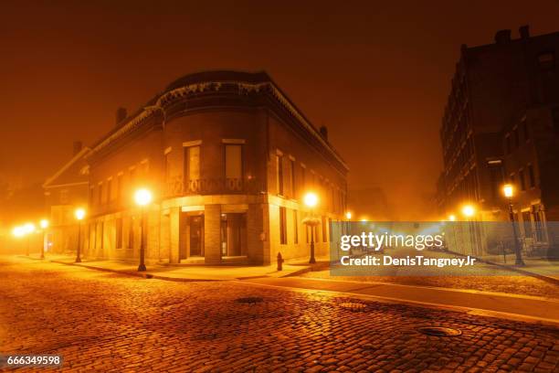 historic cobblestone streets in lowell on a foggy night - industrial revolution stock pictures, royalty-free photos & images