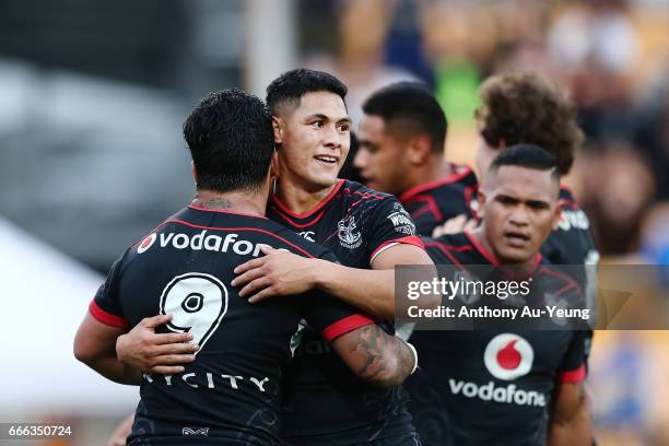 Roger Tuivasa-Sheck of the Warriors celebrates with teammate Issac Luke after Ken Maumalo's try during the round six NRL match between the New...