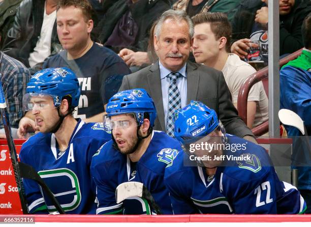 Head coach Willie Desjardins of the Vancouver Canucks looks on from the bench during their NHL game against the Edmonton Oilers at Rogers Arena April...