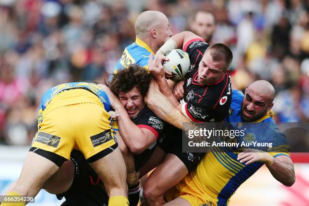 Kieran Foran and Charlie Gubb of the Warriors are tackled by Tepai Moeroa, Beau Scott and Tim Mannah of the Eels during the round six NRL match...