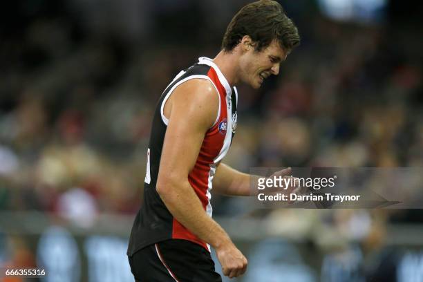 Dylan Roberton of the Saints comes to the bench in pain during the round three AFL match between the St Kilda Saints and the Brisbane Lions at Etihad...