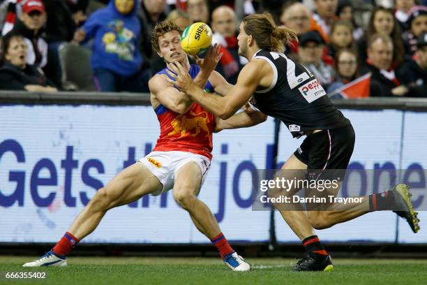 Ryan Lester of the Lions is tackled by Josh Bruce of the Saints during the round three AFL match between the St Kilda Saints and the Brisbane Lions...