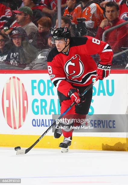 Beau Bennett of the New Jersey Devils plays the puck against the Philadelphia Flyers during the game at Prudential Center on April 4, 2017 in Newark,...