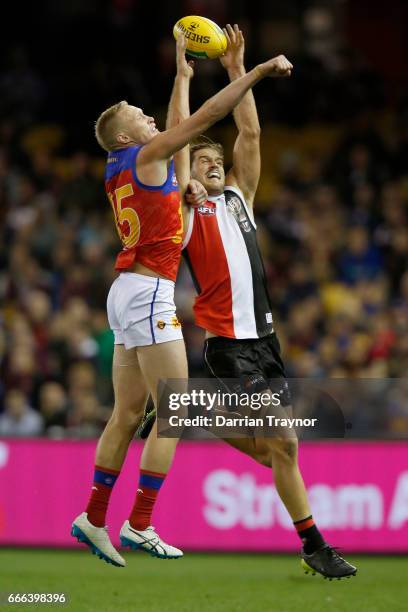 Josh Bruce of the Saints marks the ball in front of Jack Frost of the Lions during the round three AFL match between the St Kilda Saints and the...