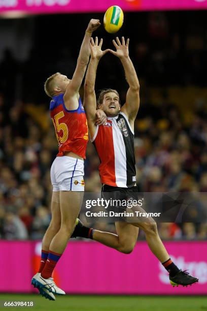 Josh Bruce of the Saints marks the ball in front of Jack Frost of the Lions during the round three AFL match between the St Kilda Saints and the...