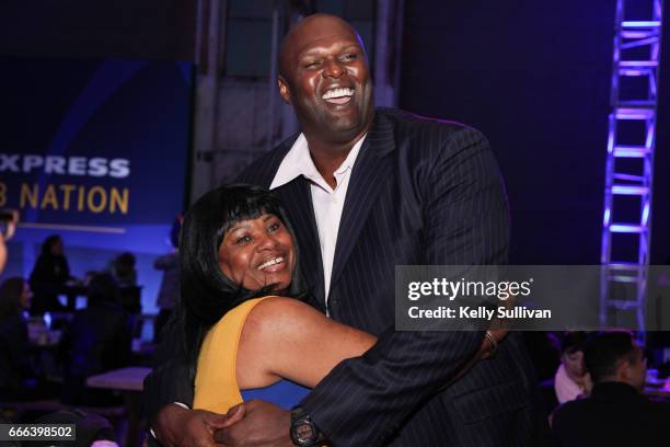 Golden State Warriors Legend Adonal Foyle poses for a photo with a fan at the final American Express "All for Dub Nation" Watch Party on April 8,...