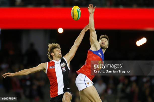 Tom Hickey of the Saints and Stefan Martin of the Lions compete in the ruck during the round three AFL match between the St Kilda Saints and the...