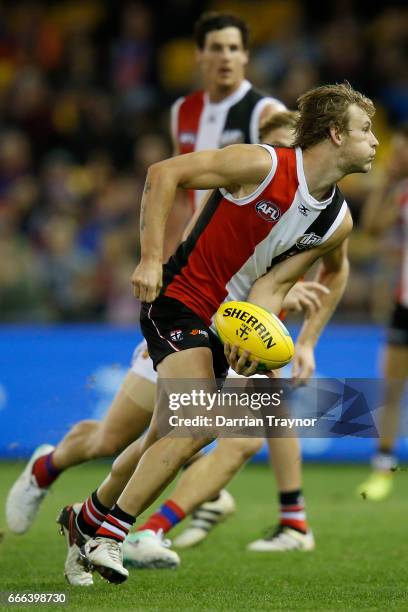 Jimmy Webster of the Saints handballs during the round three AFL match between the St Kilda Saints and the Brisbane Lions at Etihad Stadium on April...