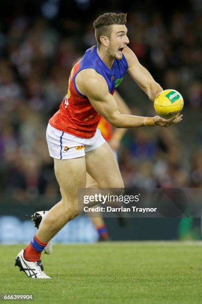 Daniel McStay of the Lions handballs during the round three AFL match between the St Kilda Saints and the Brisbane Lions at Etihad Stadium on April...