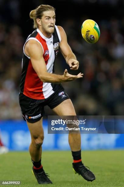 Josh Bruce of the Saints handballs during the round three AFL match between the St Kilda Saints and the Brisbane Lions at Etihad Stadium on April 9,...