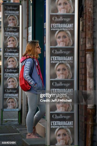 Young woman looks into the window of a paper shop in the town center on February 15, 2017 in Henin Beaumont, France. The former mining town in...