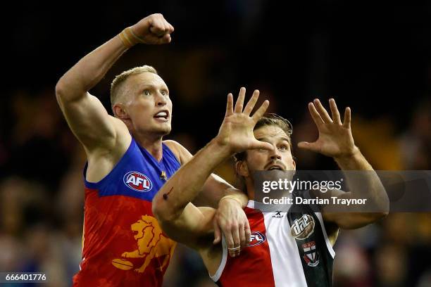 Josh Bruce of the Saints marks the ball in front of Jack Frost of the Lions during the round three AFL match between the St Kilda Saints and the...