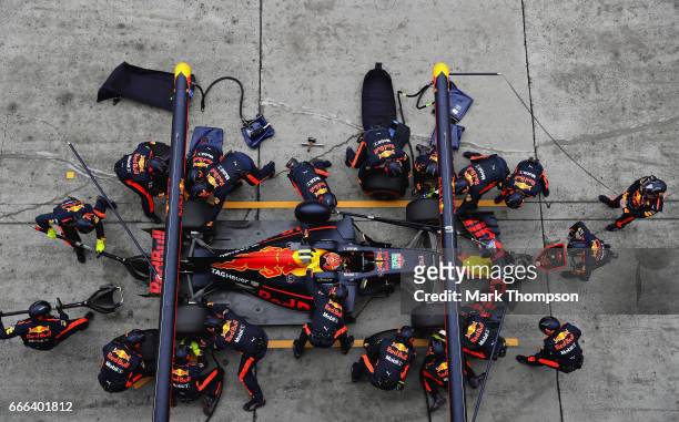 Max Verstappen of the Netherlands driving the Red Bull Racing Red Bull-TAG Heuer RB13 TAG Heuer makes a pit stop for new tyres during the Formula One...