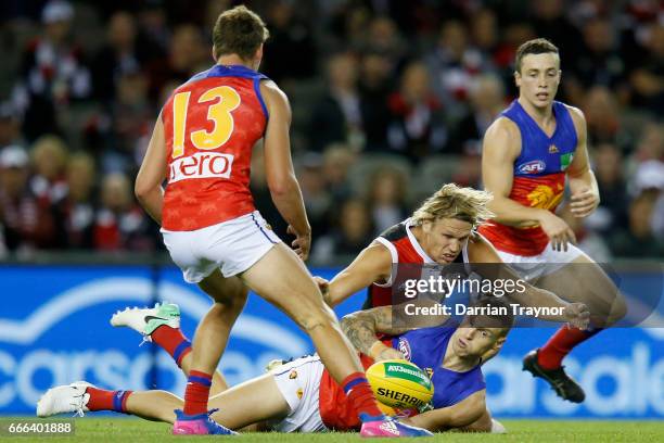 Mitch Robinson of the Lions handballs during the round three AFL match between the St Kilda Saints and the Brisbane Lions at Etihad Stadium on April...