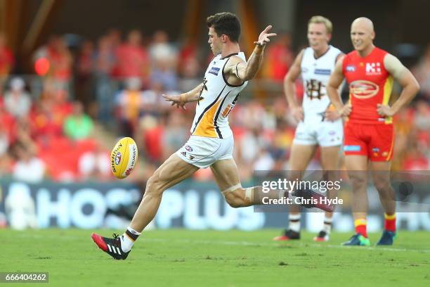 Jaeger O'Meara of the Hawks kicks a goal during the round three AFL match between the Gold Coast Suns and the Hawthorn Hawks at Metricon Stadium on...