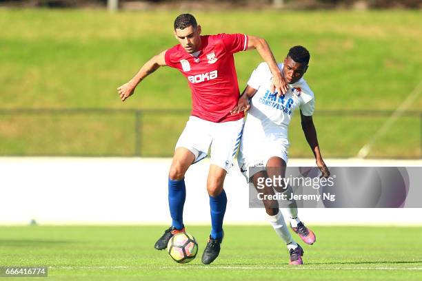 Yianni Fragogiannis of United 58 and Hassan Jalloh of the White Eagles challenge for the ball during the Men's NSW NPL match between Sydney United 58...