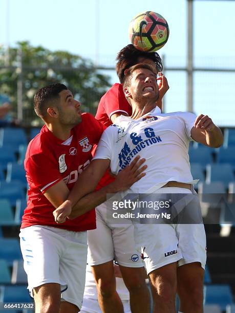 David Vrankovic of the White Eagles and Yianni Fragogiannis of United 58 head the ball during the Men's NSW NPL match between Sydney United 58 FC and...