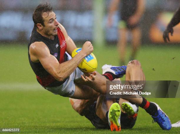 Jobe Watson of the Bombers is tackled by Jacob Weitering of the Blues during the round three AFL match between the Carlton Blues and the Essendon...