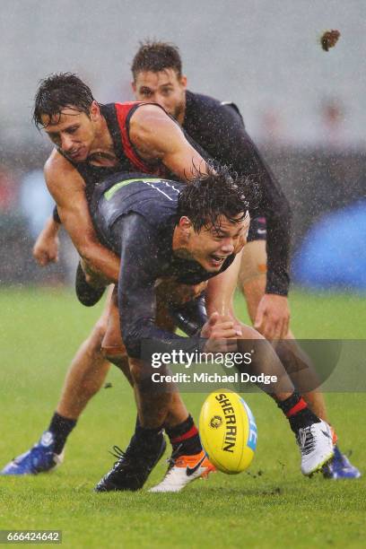 Jack Silvagni of the Blues handballs away from Mark Baguley of the Bombers during the round three AFL match between the Carlton Blues and the...