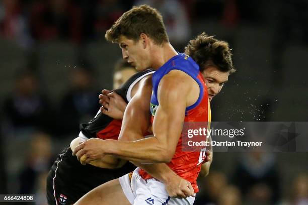 Dylan Roberton of the Saints and Jarrod Berry of the Lions collide during the round three AFL match between the St Kilda Saints and the Brisbane...