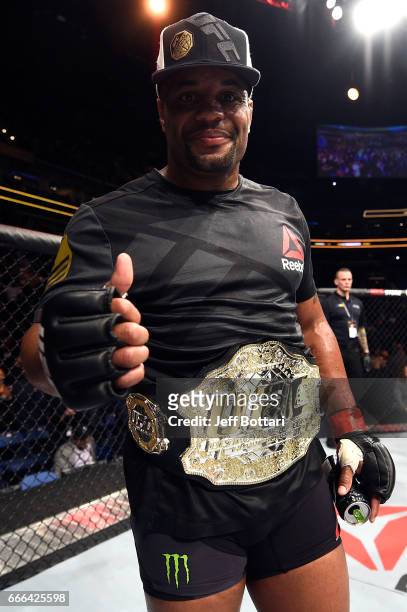 Daniel Cormier reacts to his submission victory against Anthony Johnson in their UFC light heavyweight championship bout during the UFC 210 event at...