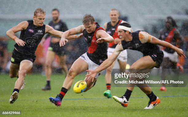 Sam Kerridge of the Blues, Michael Hurley of the Bombers and Jacob Weitering of the Blues compete for the ball during the 2017 AFL round 03 match...