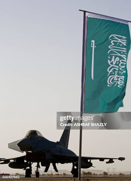 Plane sits on the tarmac next to a Saudi Arabian flag during a joint Sudan and Saudi Arabia air force drill at the Marwa air base, near Meroe some...