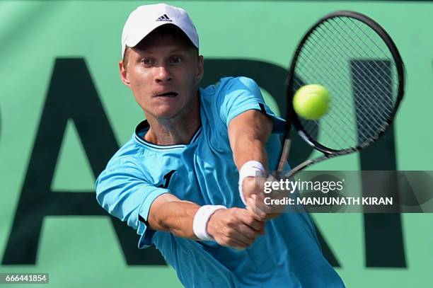 Uzbekistan player Sanjar Fayziev plays a shot during his singles match against Ramkumar Ramanathan at the Davis Cup Asia Oceania group one tie match...