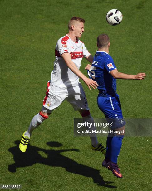 Timo Baumgartl of Stuttgart jumps for a header with Florian Kamberi of Karlsruhe during the Second Bundesliga match between VfB Stuttgart and...