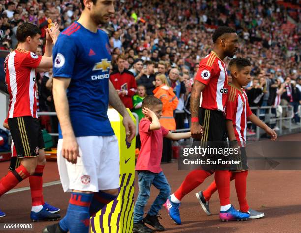 Bradley Lowery walks out with Jermain Defoe of Sunderland during the Premier League match between Sunderland and Manchester United at Stadium of...