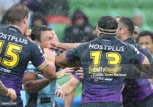 James Maloney of the Sharks argues with Dale Finucane of the Melbourne Storm and Storm players during the round six NRL match between the Melbourne...