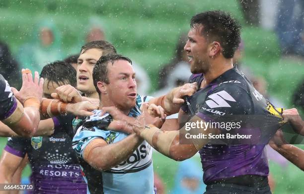 James Maloney of the Sharks argues with Dale Finucane of the Melbourne Storm and Storm players during the round six NRL match between the Melbourne...