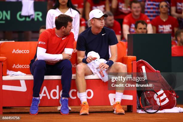Kyle Edmund of Great Britain talks to Leon Smith the Great Britain captain in his singles match against Jeremy Chardy of France during day 3 of the...