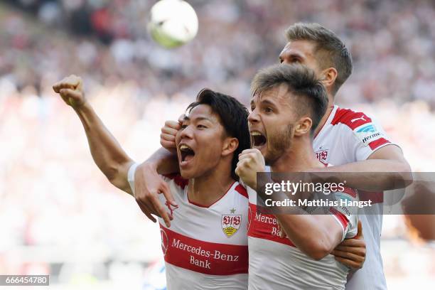 Takuma Asano of Stuttgart celebrates his team's second goal with team mates Alexandru Maxim and Simon Terodde during the Second Bundesliga match...